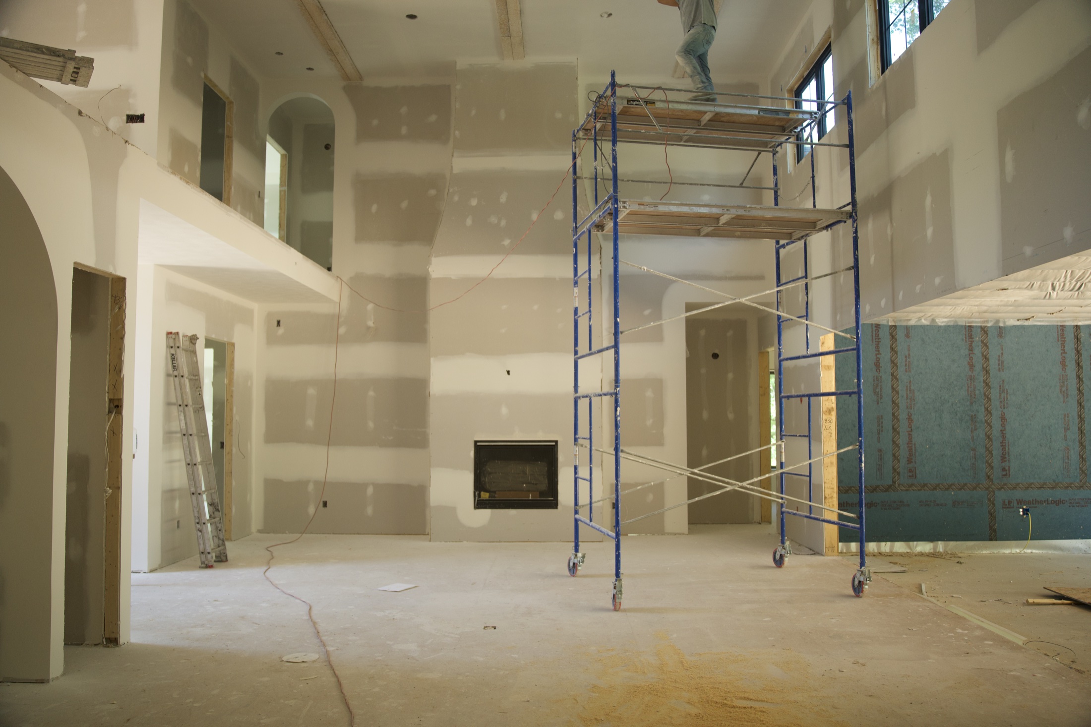 Large finished drywall room with rolling scaffold