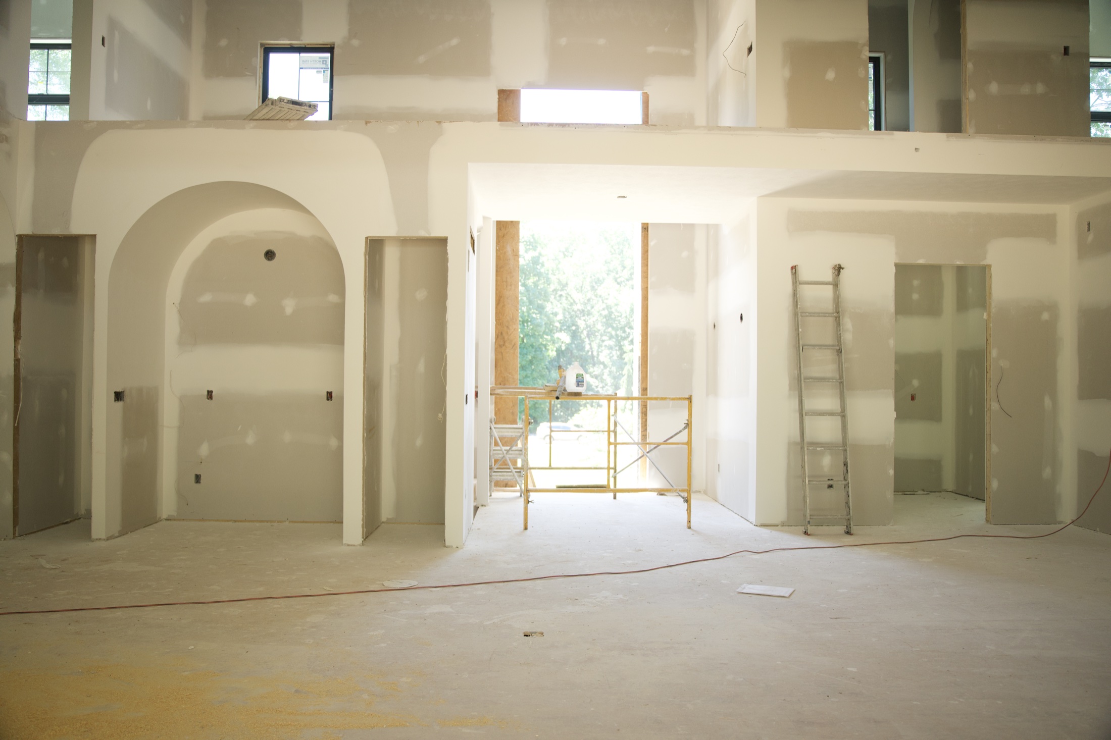 Drywall finishing around arched openings in a custom home